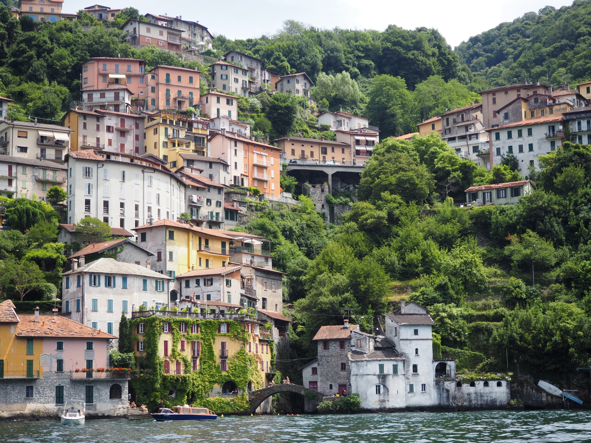 A colorful Italian village climbing from the lakeshore