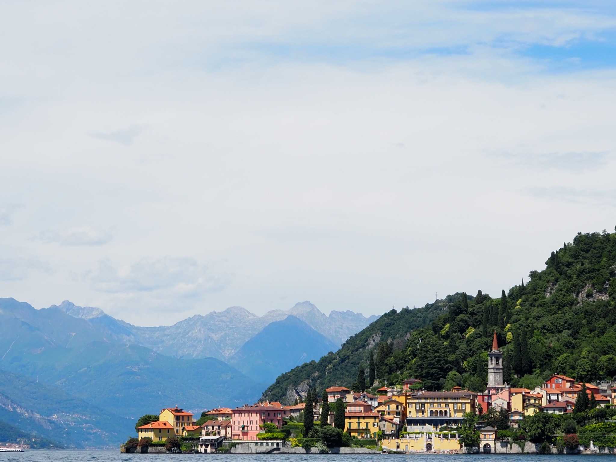 A colorful village on the shore of Lake Como beneath mountain peaks